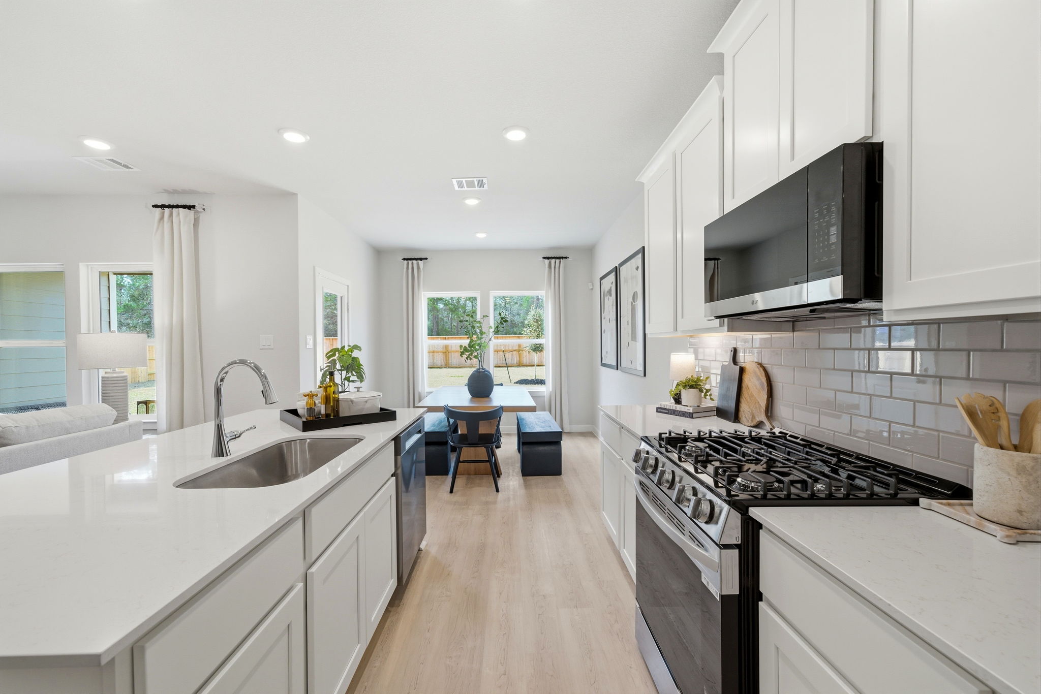 A kitchen with white cabinets.