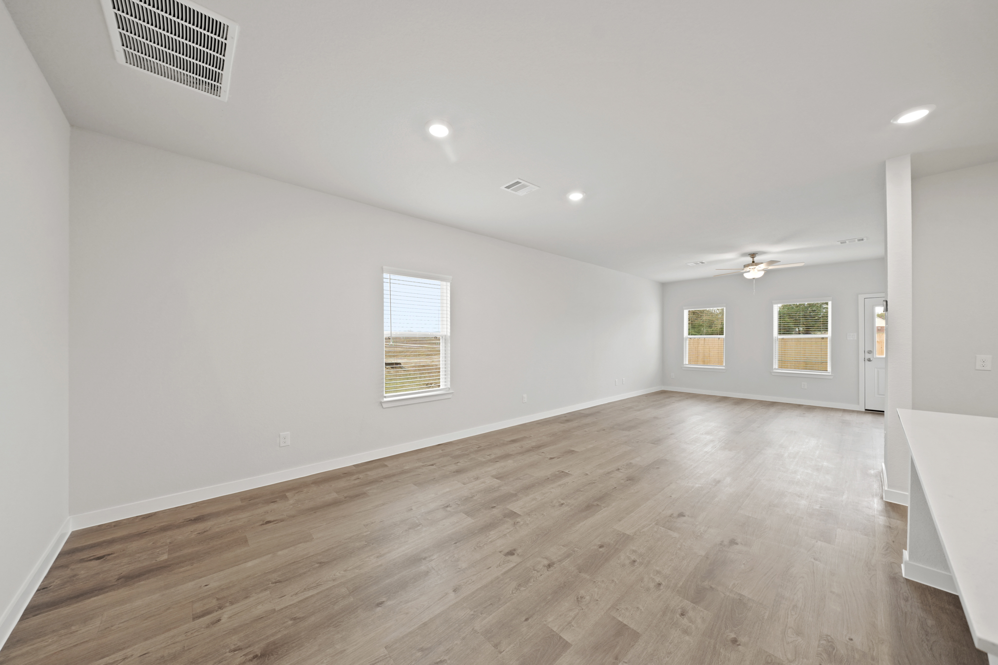 A room with a wood floor and white walls.