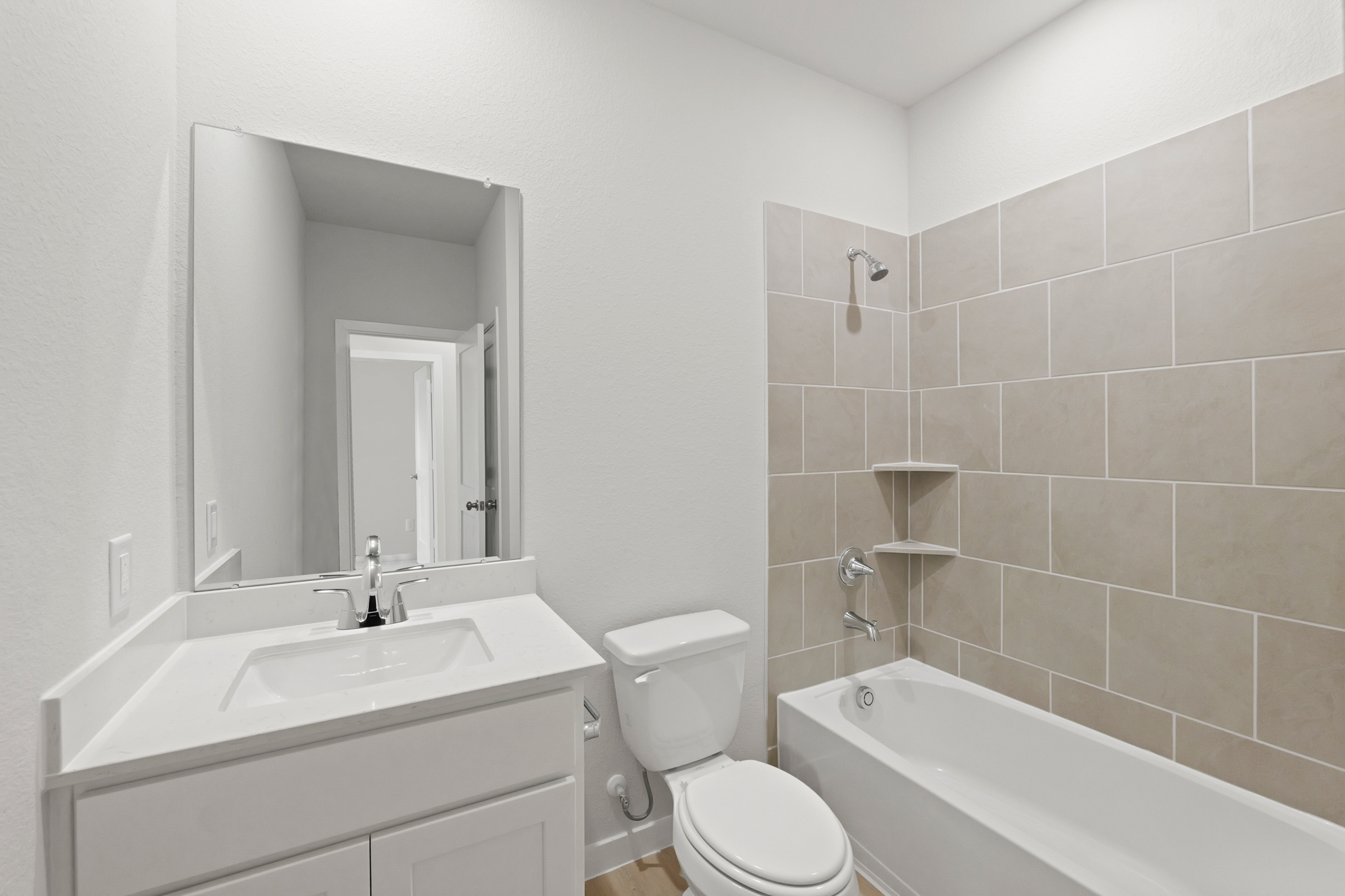 A bathroom with a tub toilet and sink.