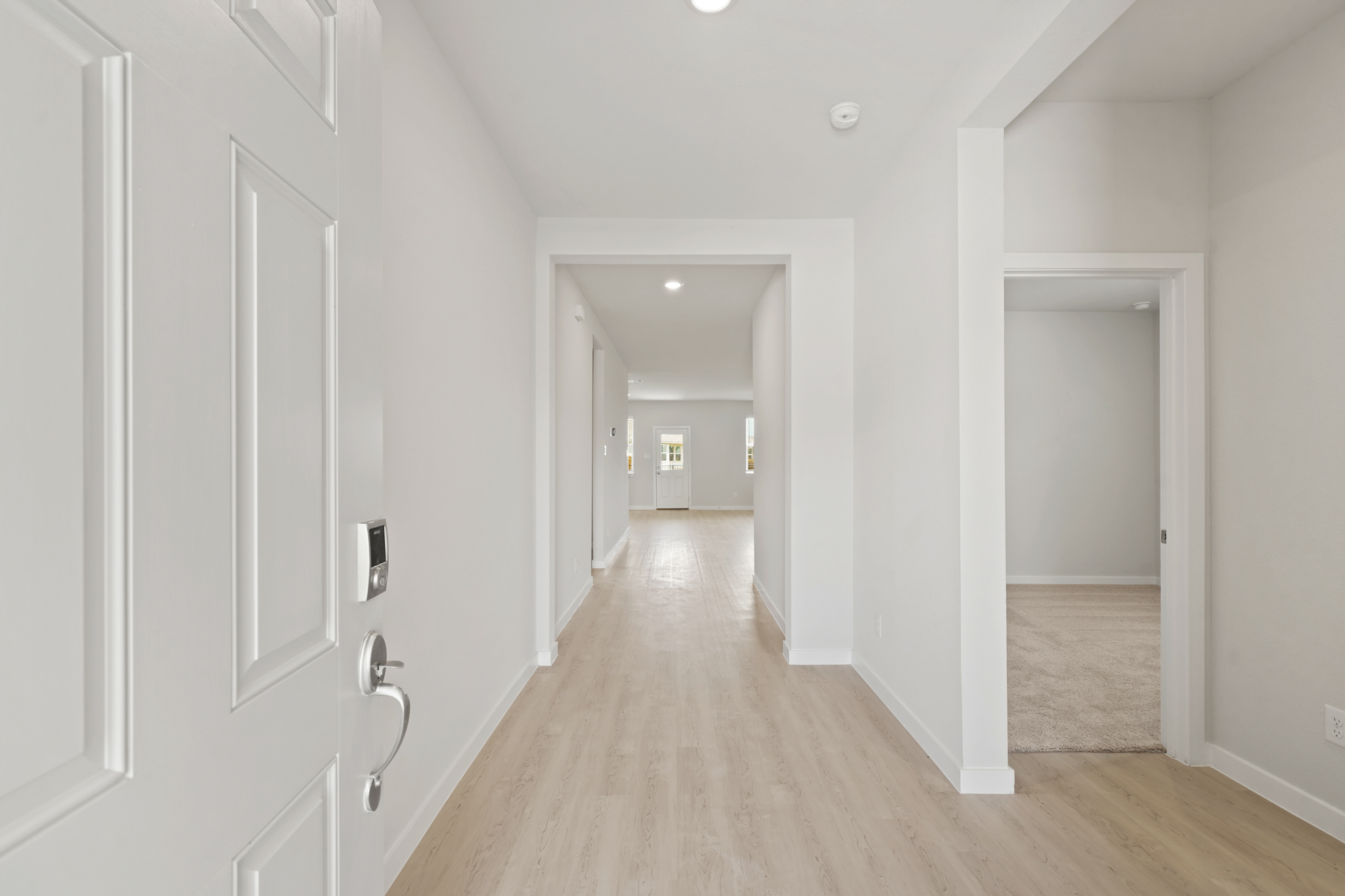 A hallway with white doors.