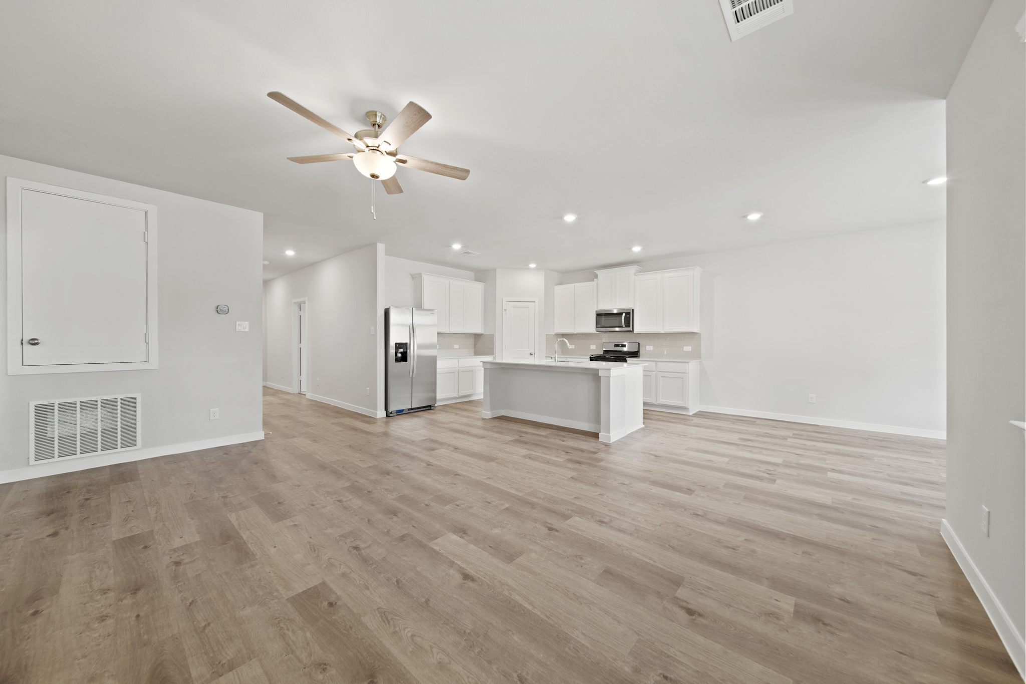 A large kitchen with white cabinets.