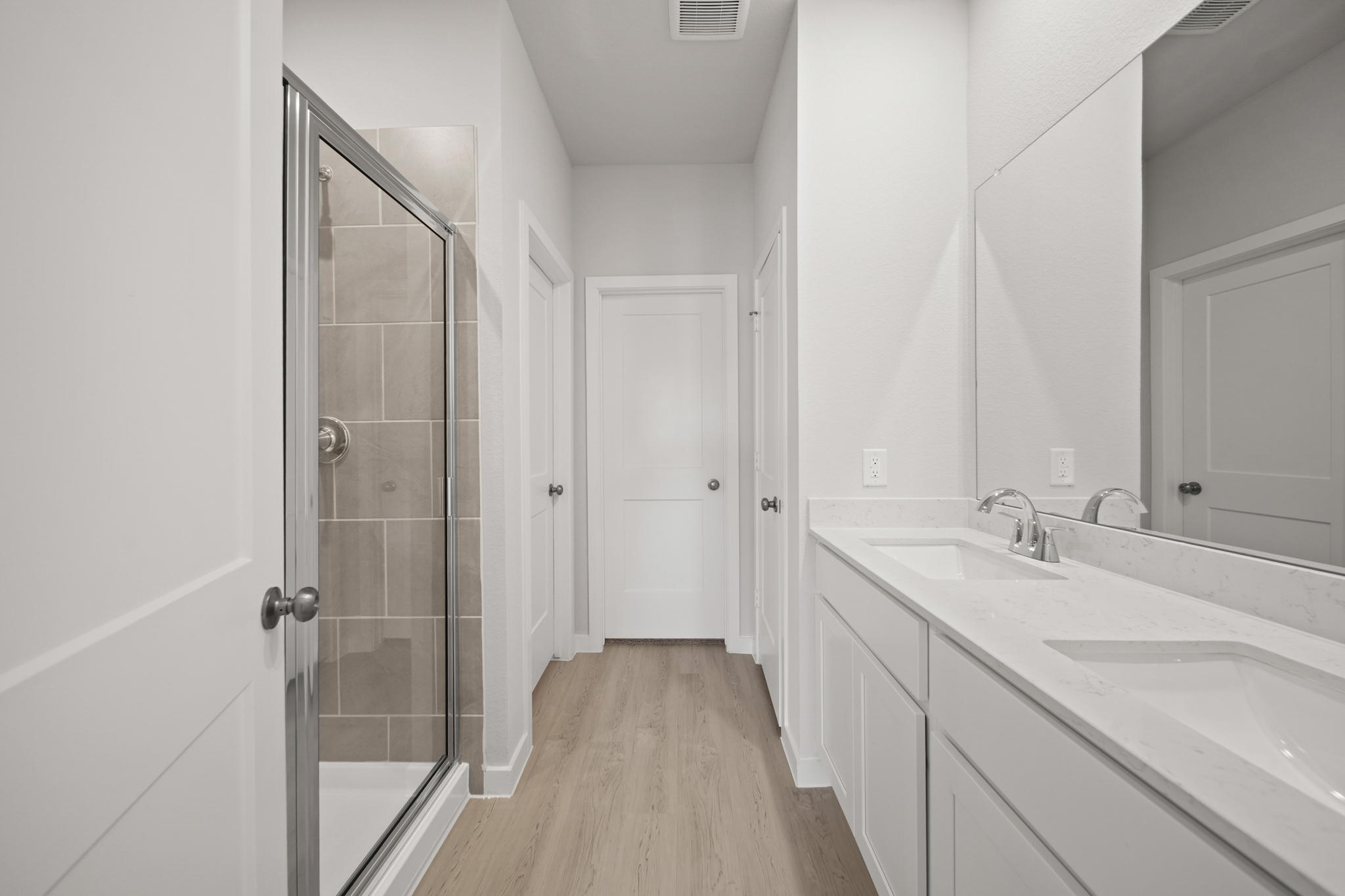 A bathroom with white cabinets.
