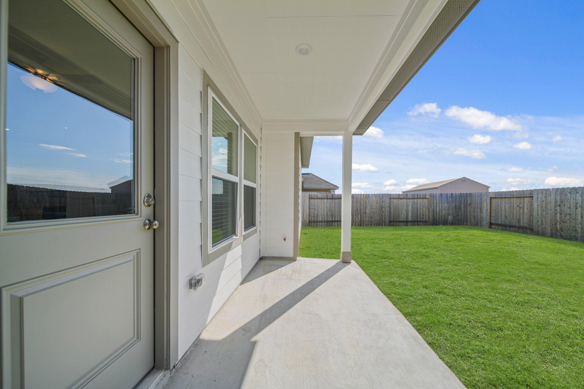 A house with a fence and grass.