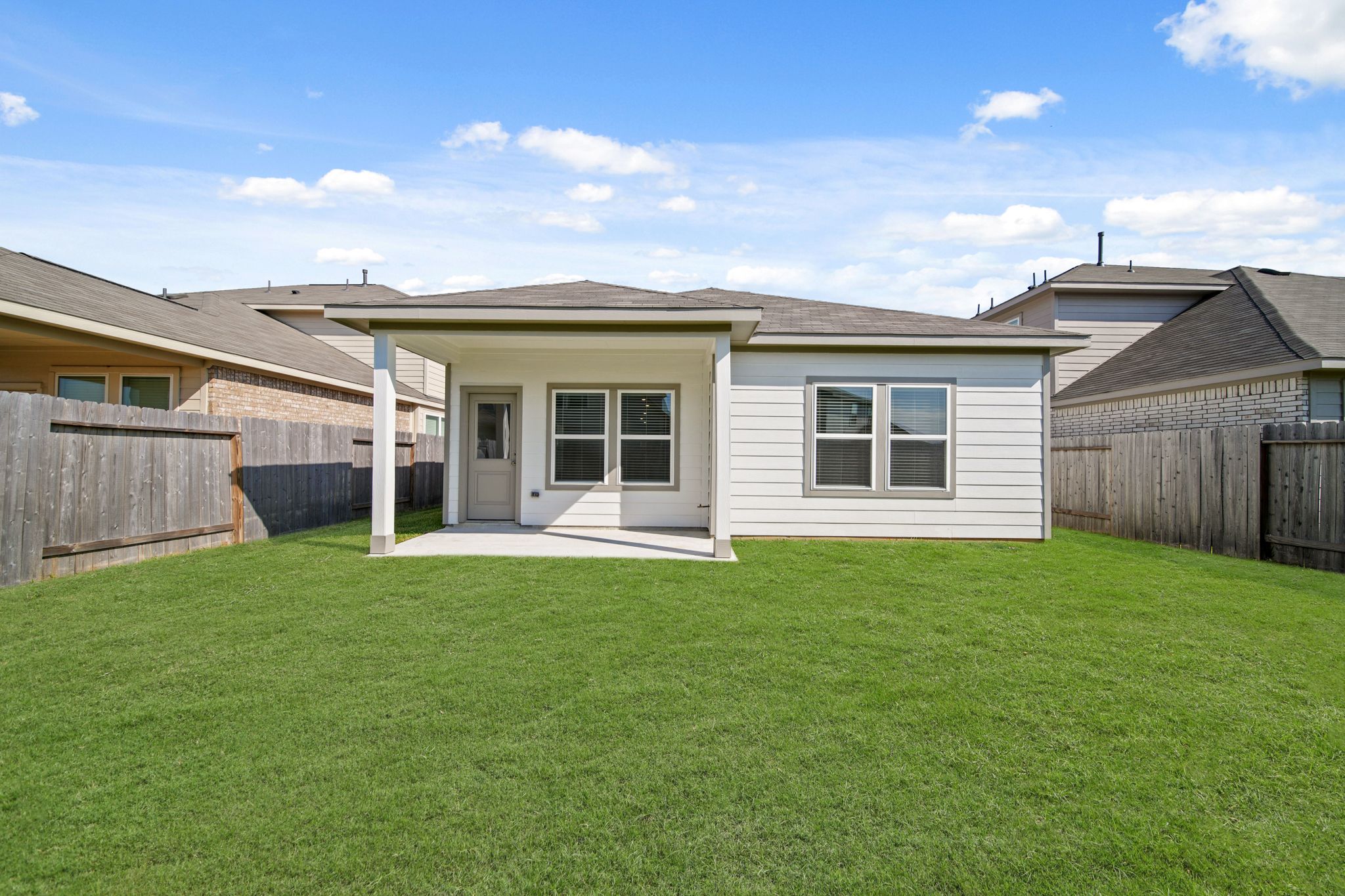 A house with a green lawn.