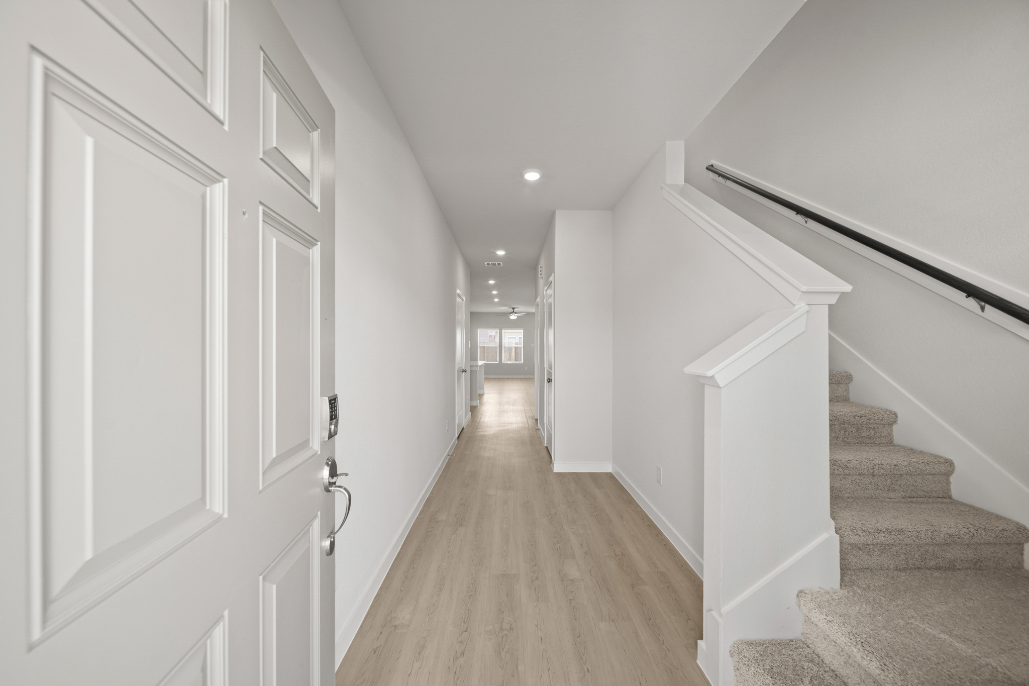 A hallway with white doors.