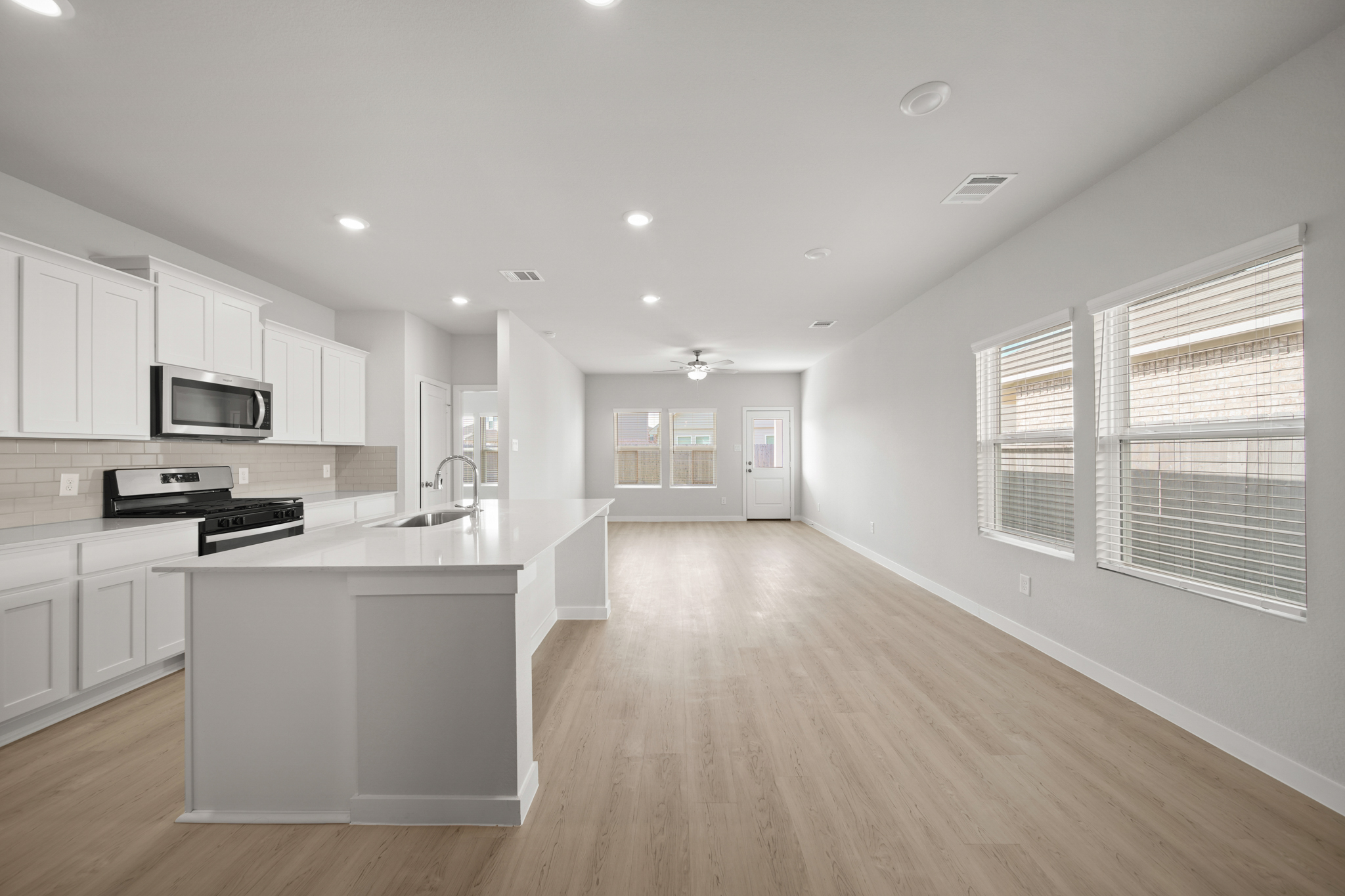 A kitchen with white cabinets.