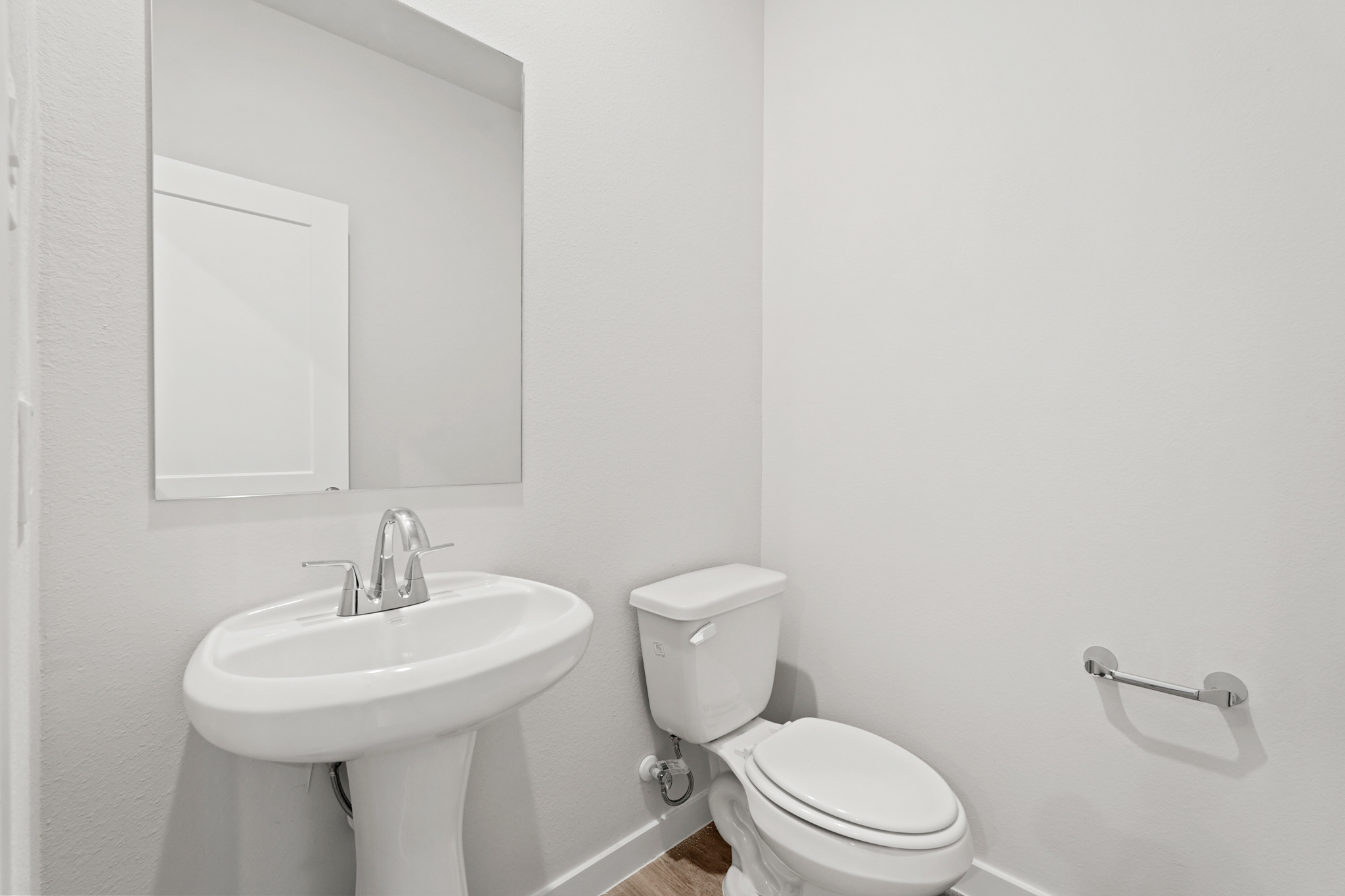 A bathroom with a toilet and sink.