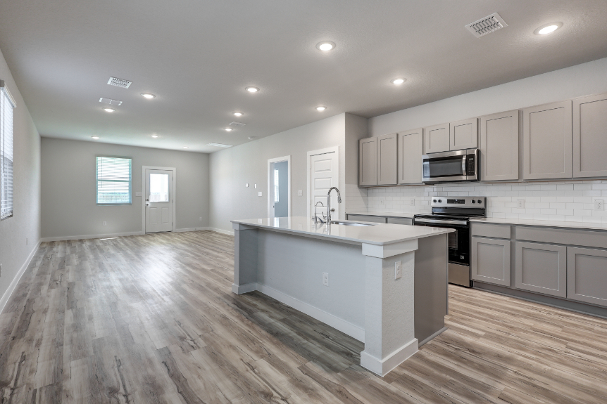 A kitchen with white cabinets.