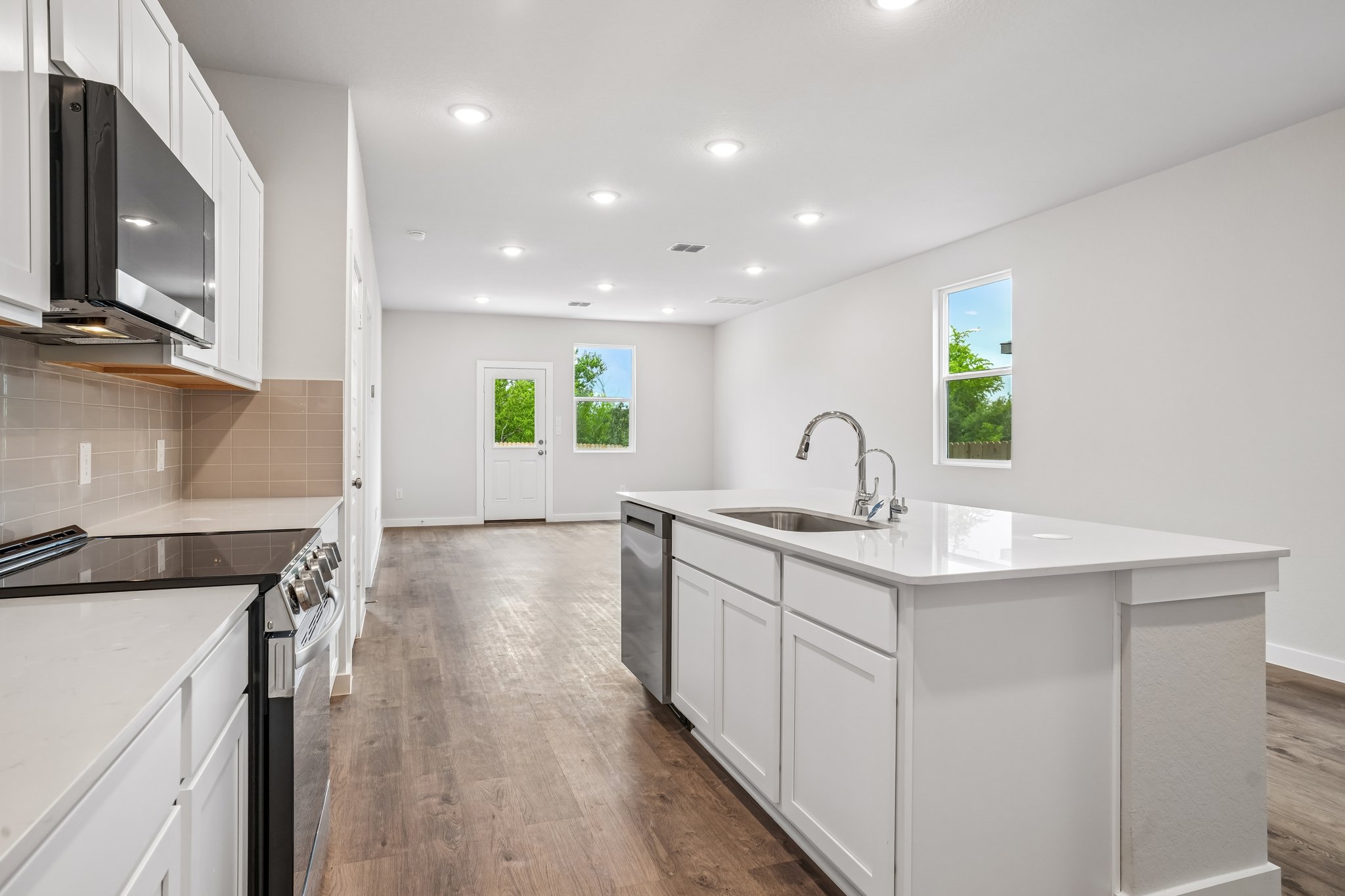 A kitchen with white cabinets.