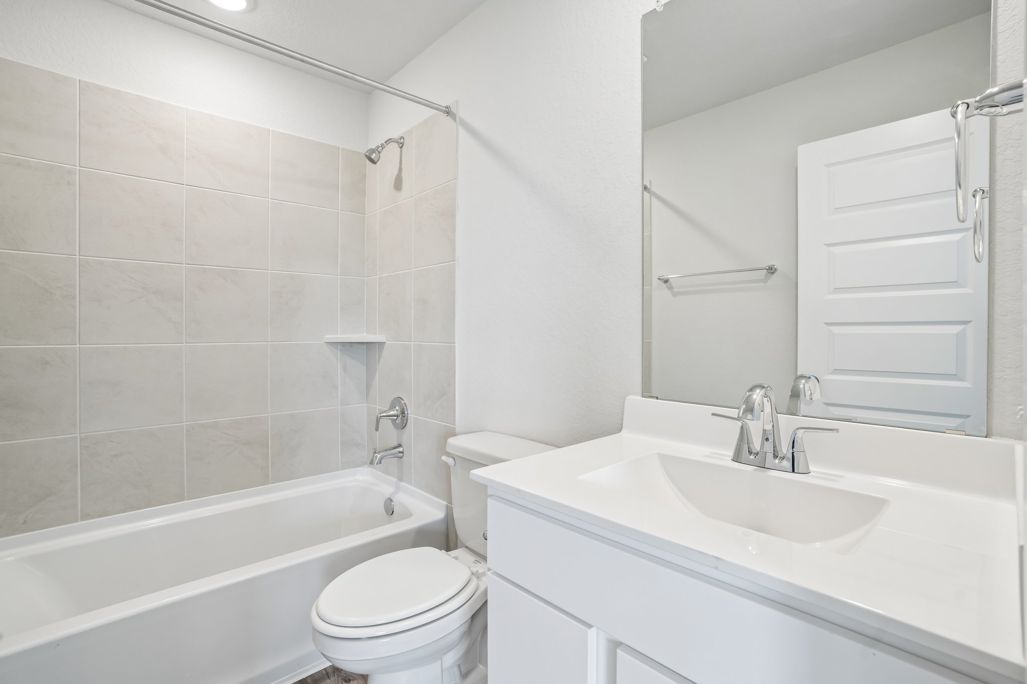 A bathroom with a sink toilet and bathtub.