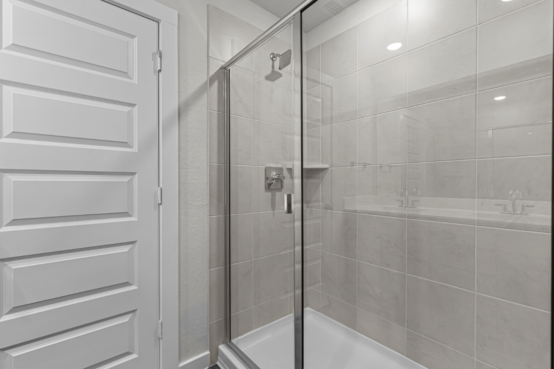 A shower with a glass door.