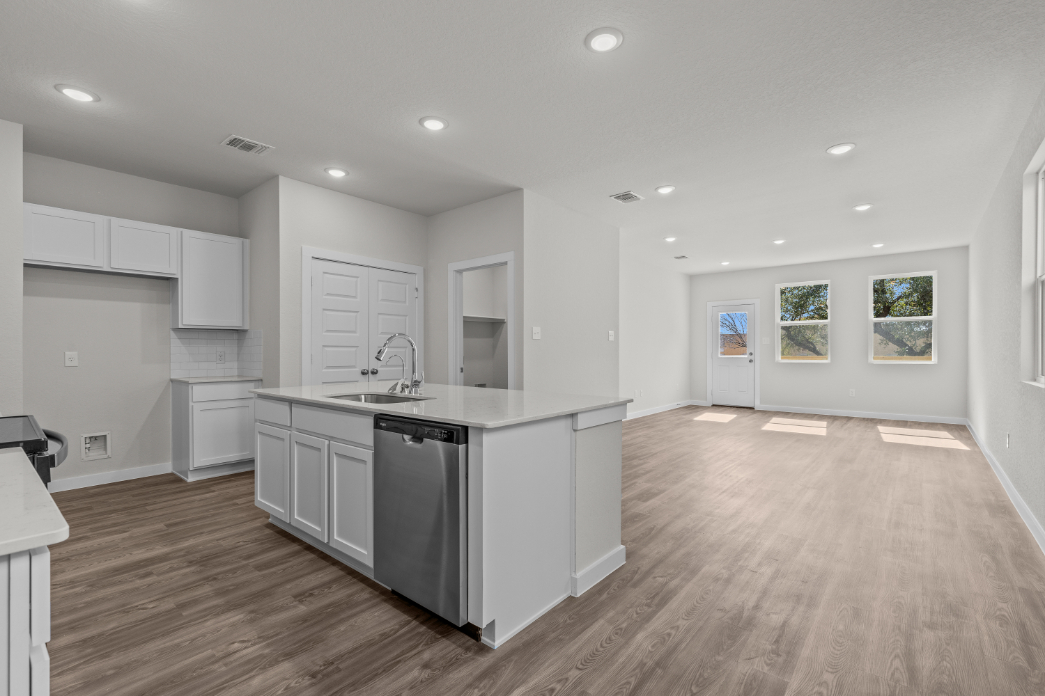 A kitchen with white cabinets.