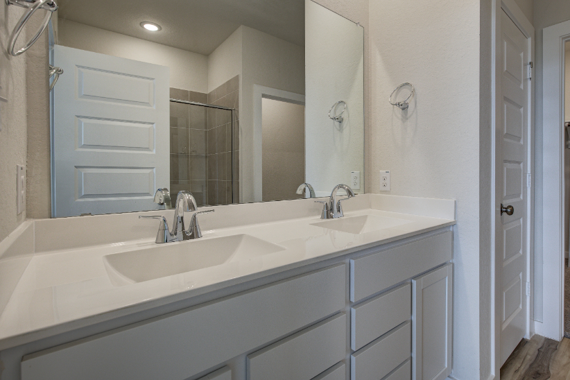 A bathroom with a large mirror.