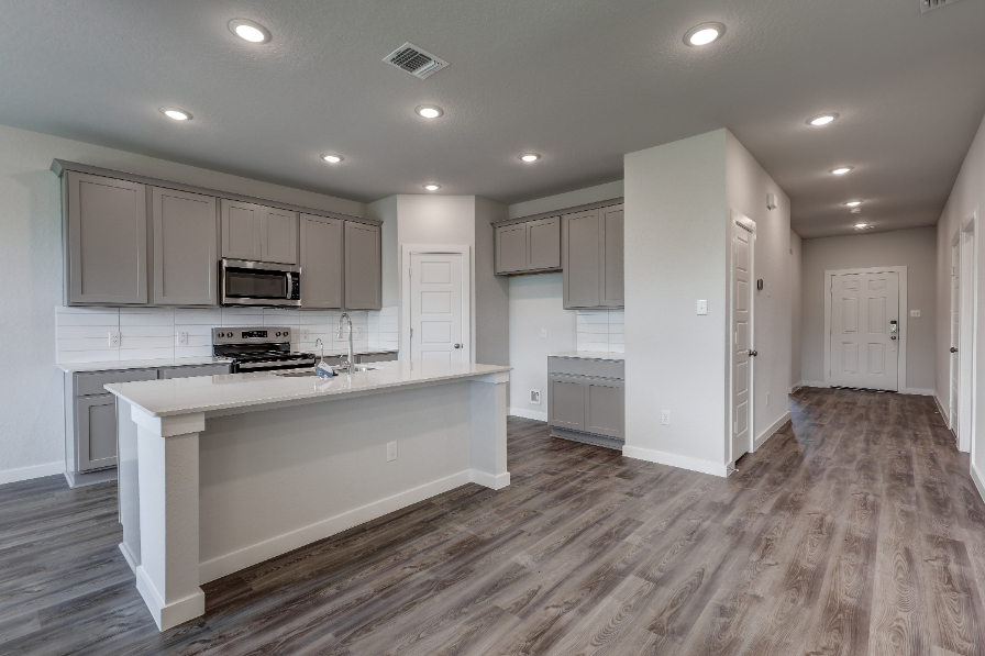 A kitchen with white cabinets.