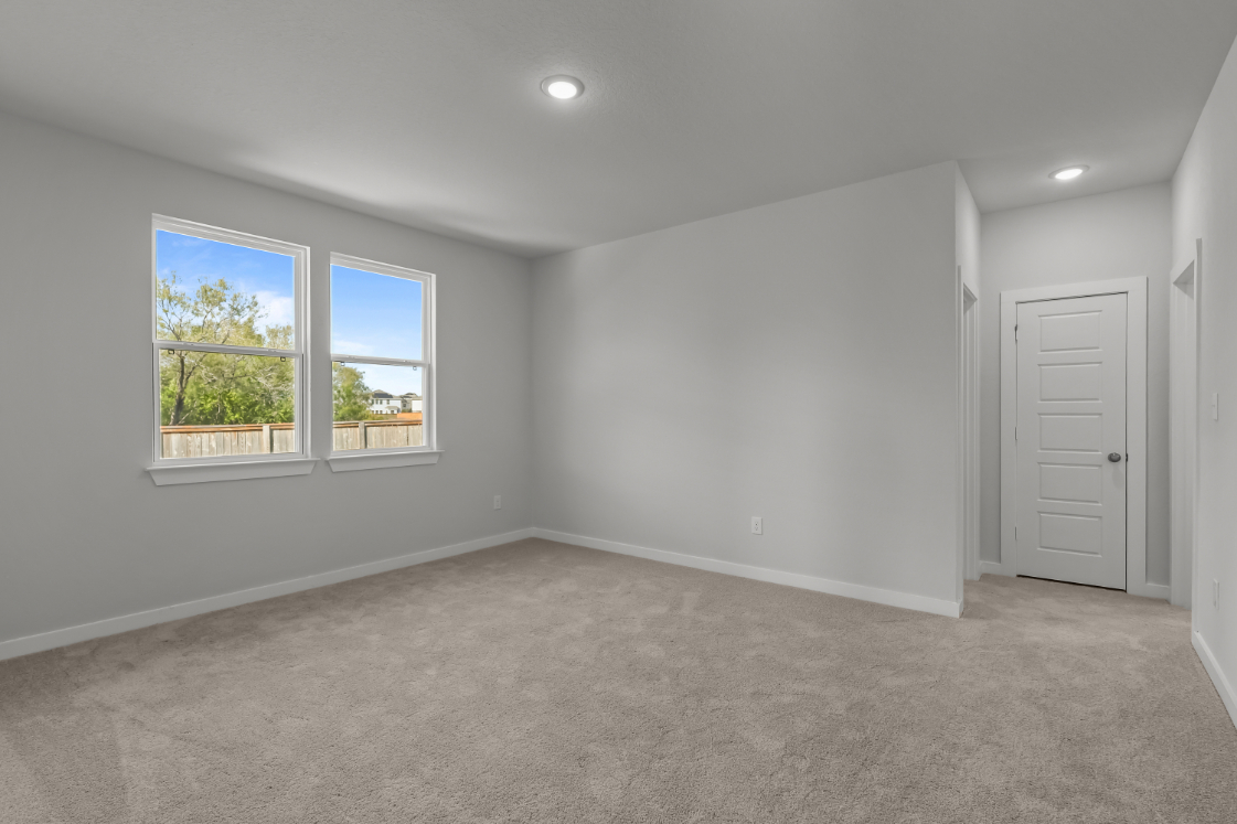 A room with a white door and windows.