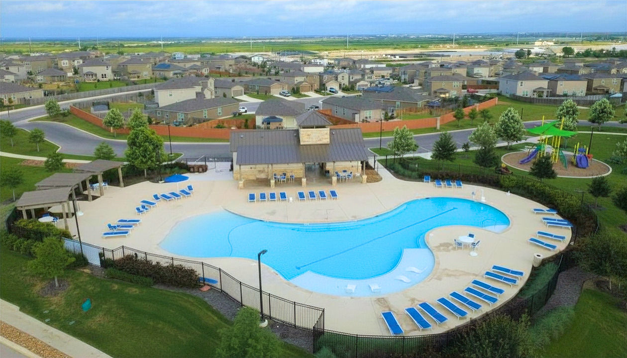 A swimming pool with a building in the background.