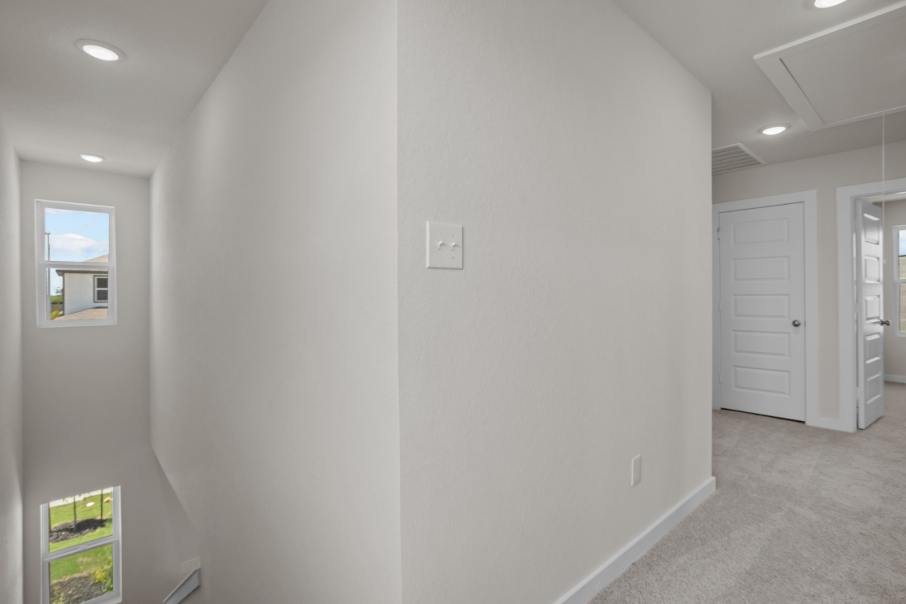 A hallway with white walls.