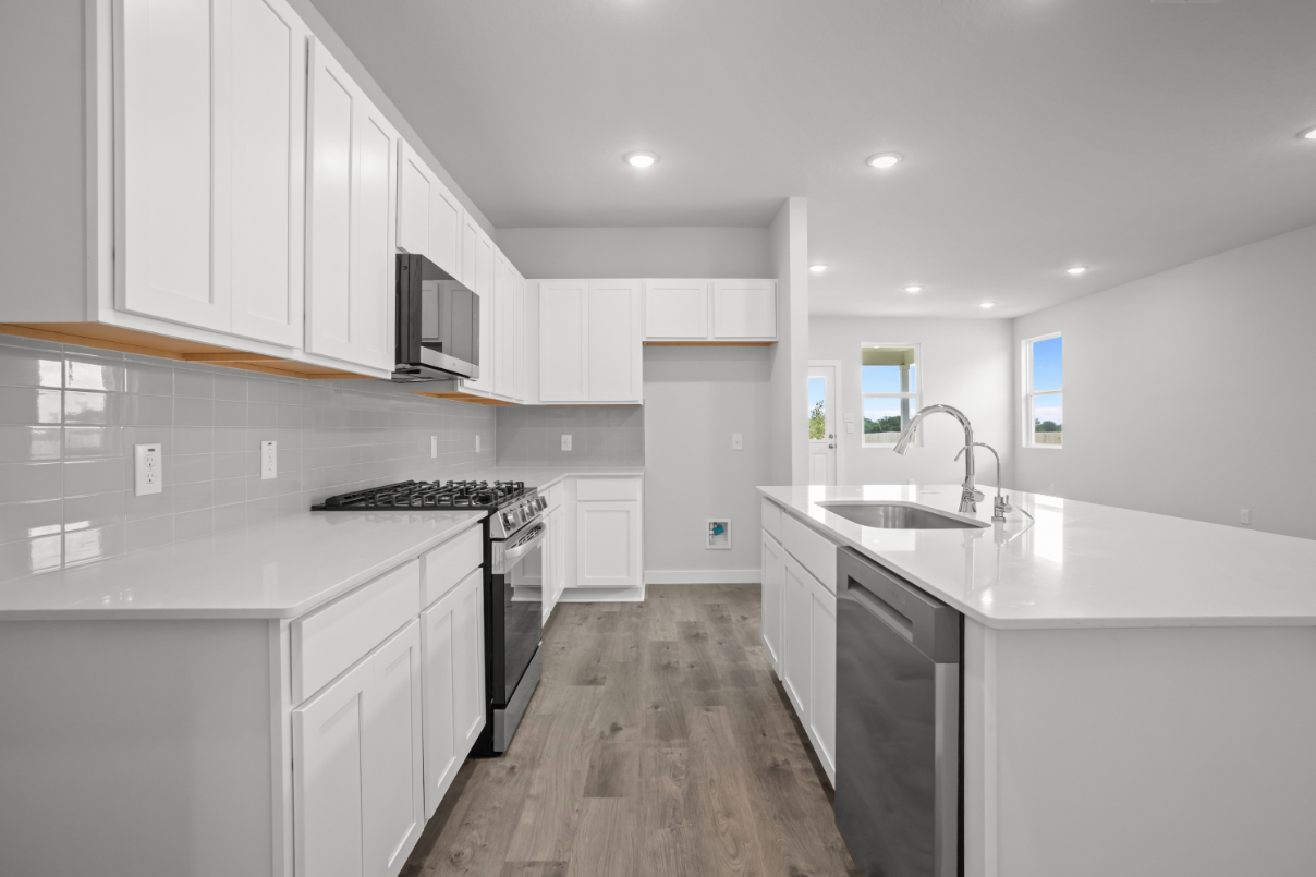 A kitchen with white cabinets.