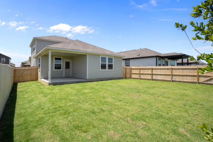 A house with a fence and grass.