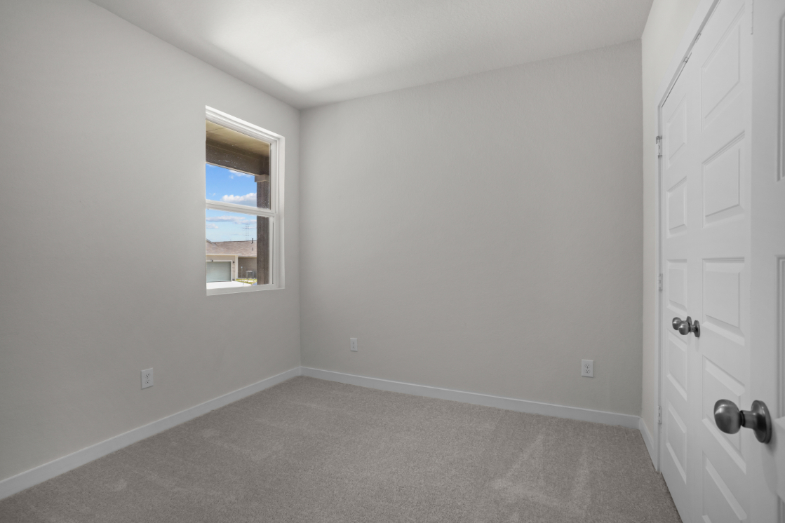 A room with white walls and a window.