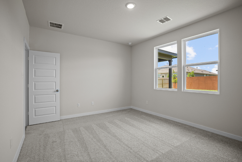 A room with a window and a door.