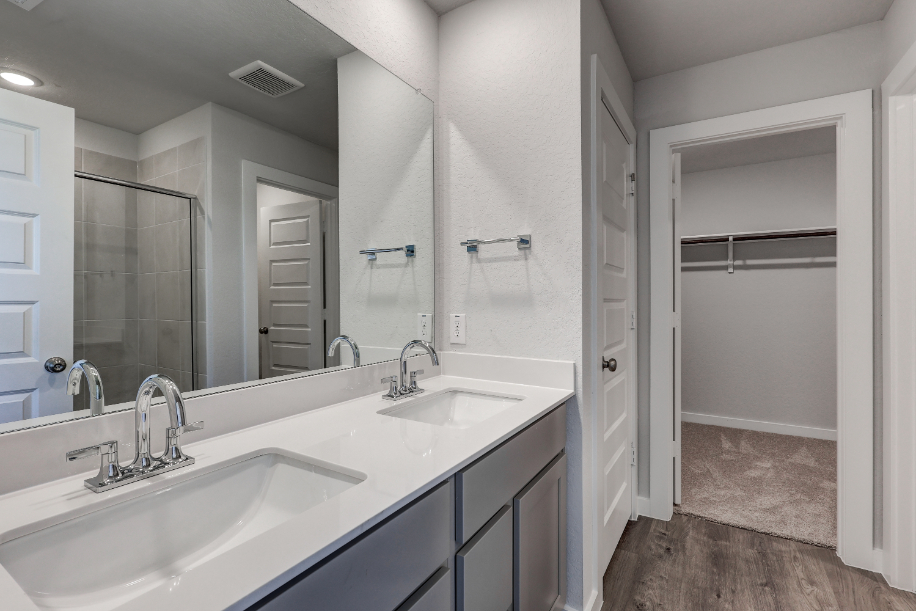 A bathroom with a large mirror.