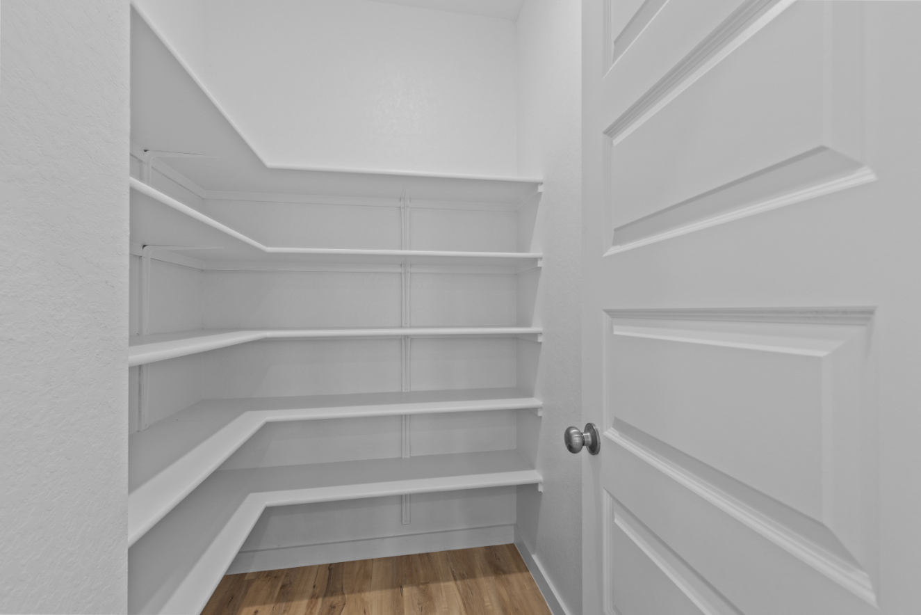 A white shelf with a door.