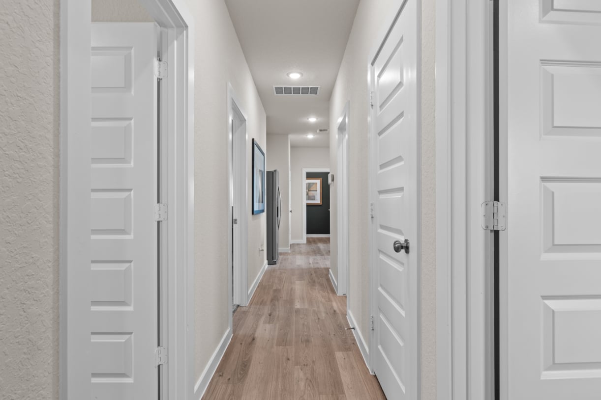 A hallway with white doors.