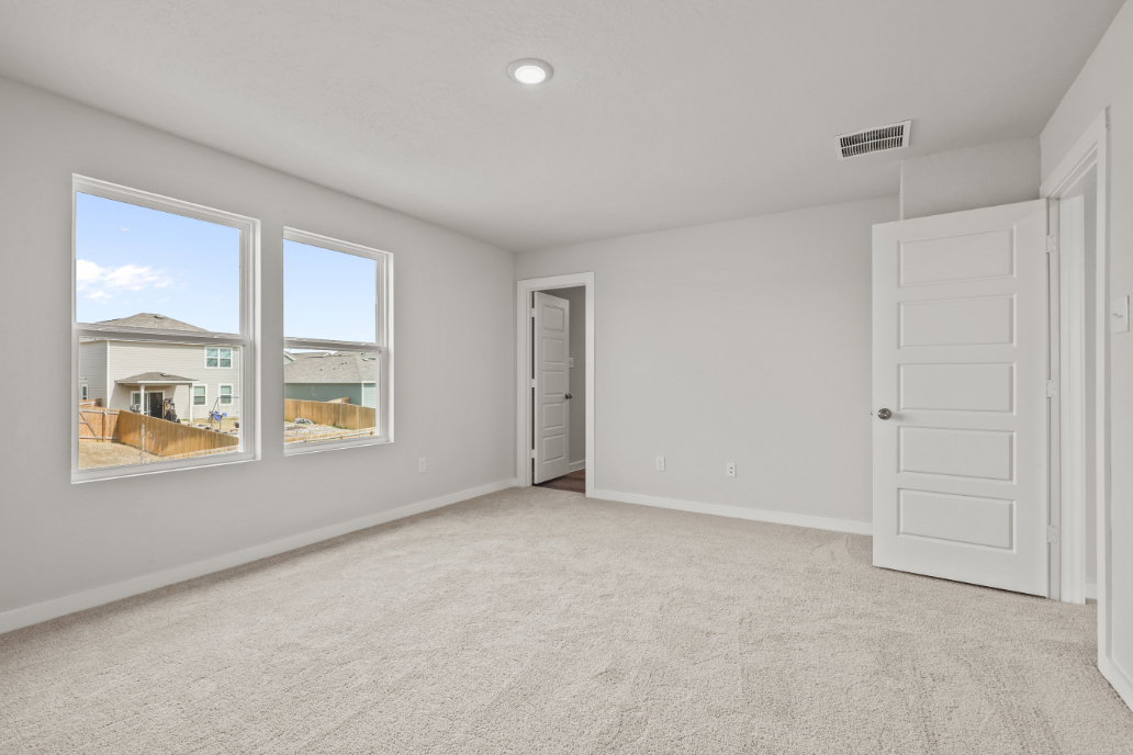 A room with white walls and a window.