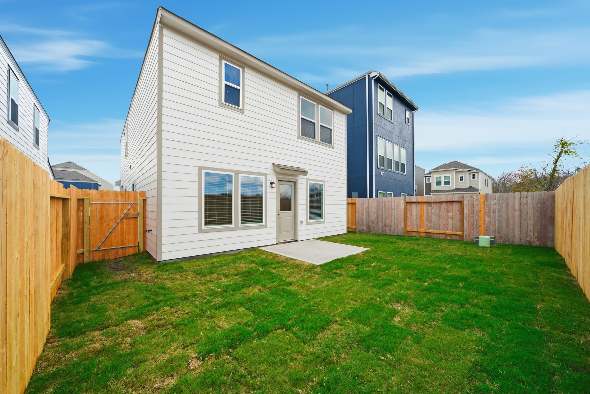 A house with a fence and grass.