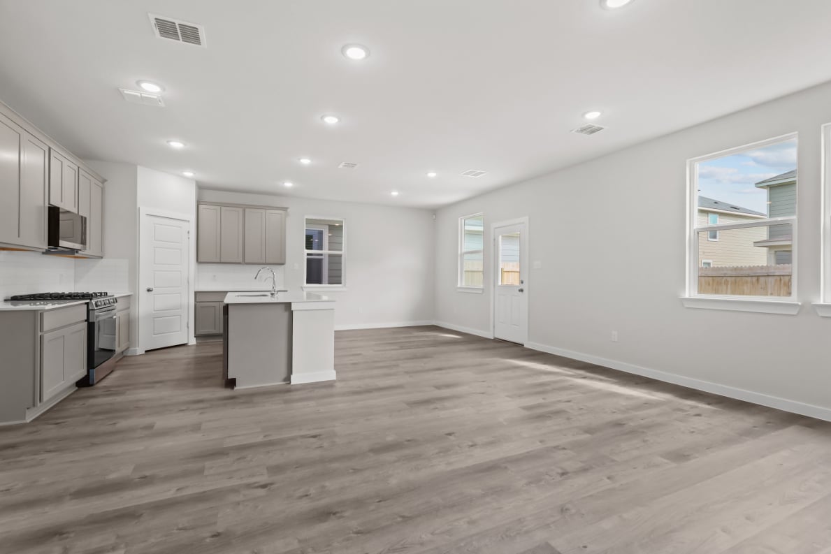 A kitchen with white cabinets.