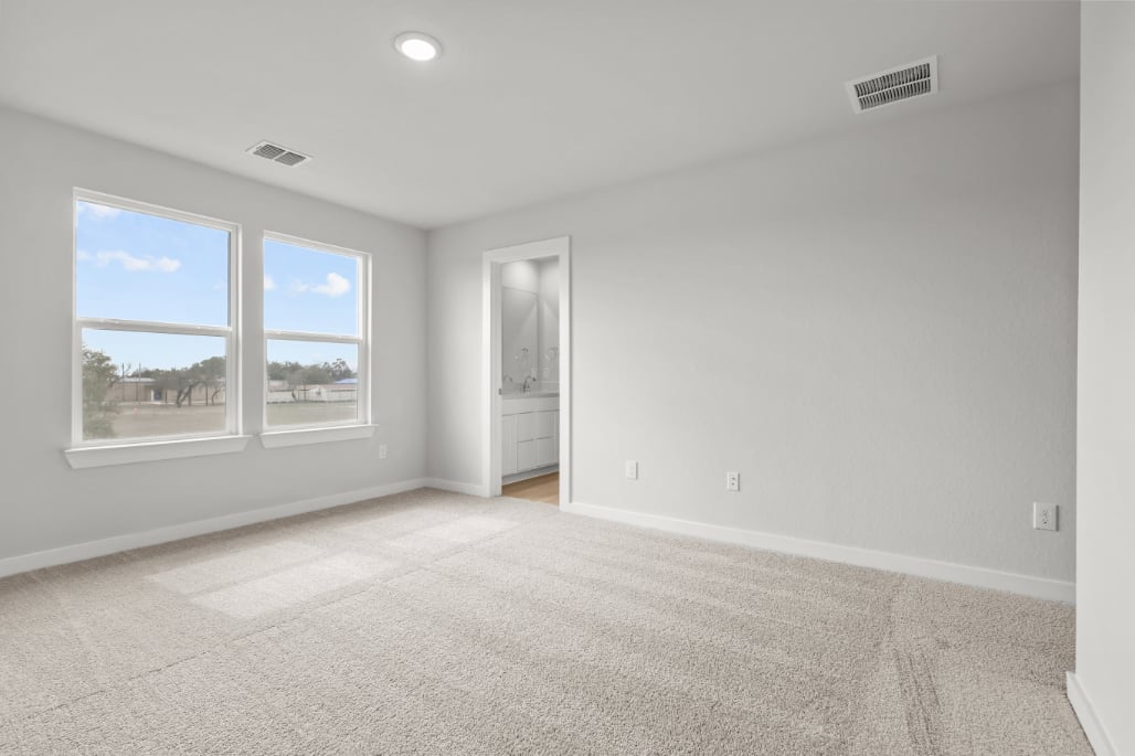 A room with a window and a carpet.