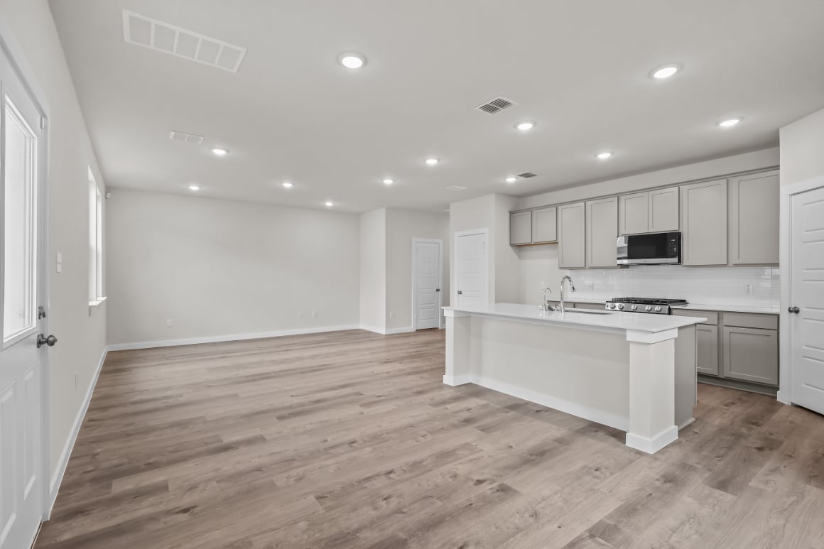 A kitchen with white cabinets.