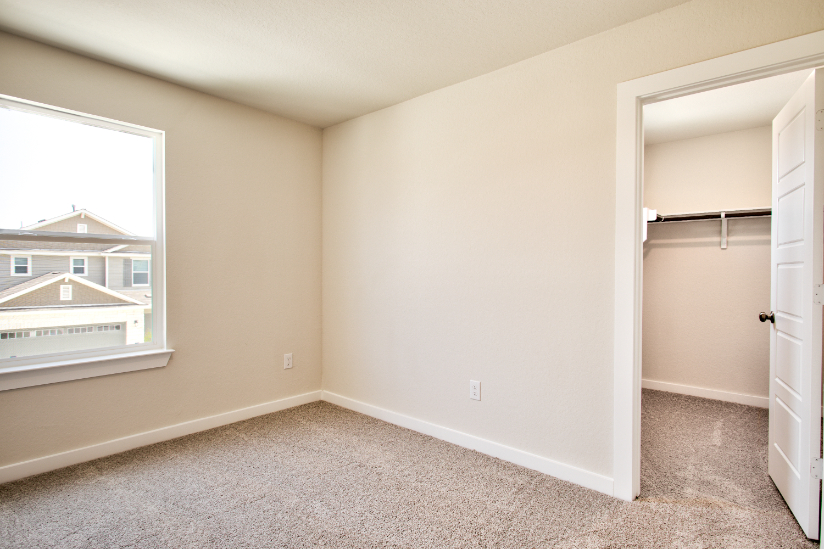 A room with a door and a window.