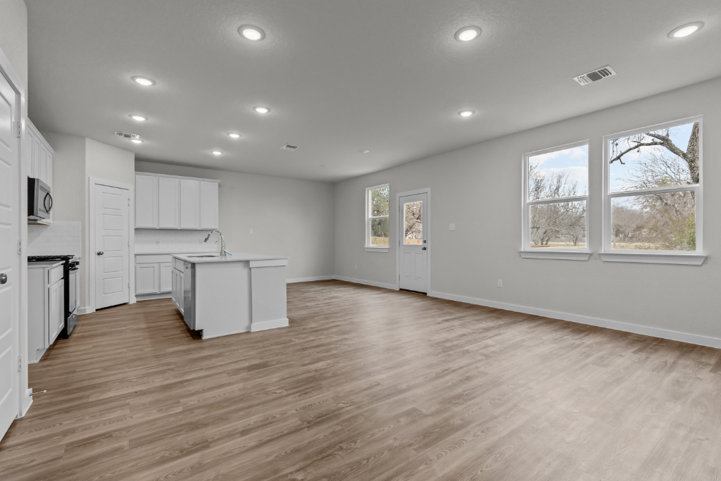 A kitchen with white cabinets.