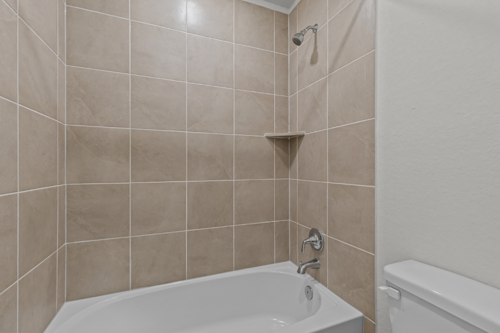 A bathtub in a bathroom.