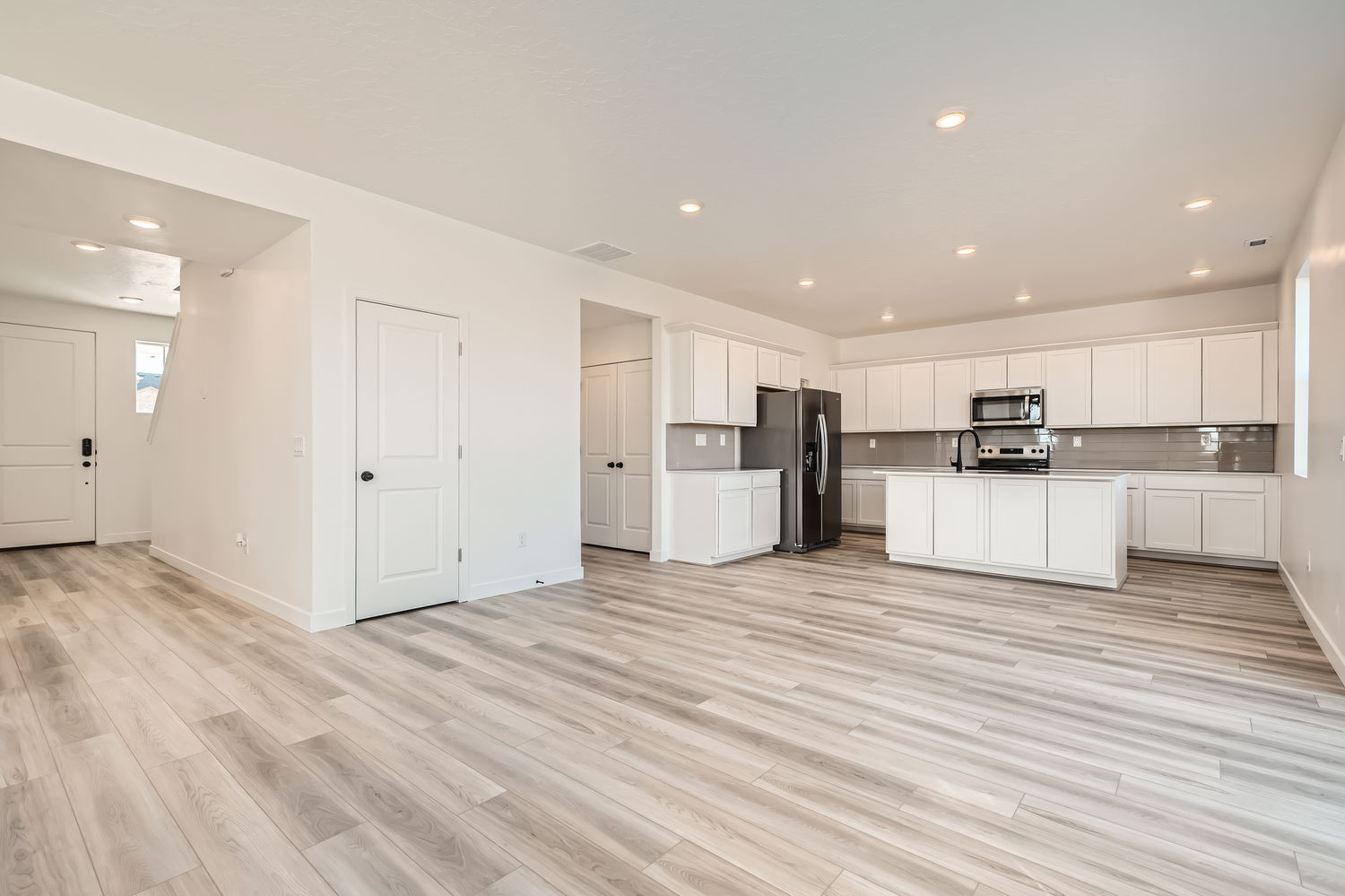 A kitchen with white cabinets.