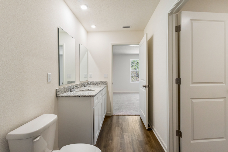 A bathroom with a tub sink and toilet.