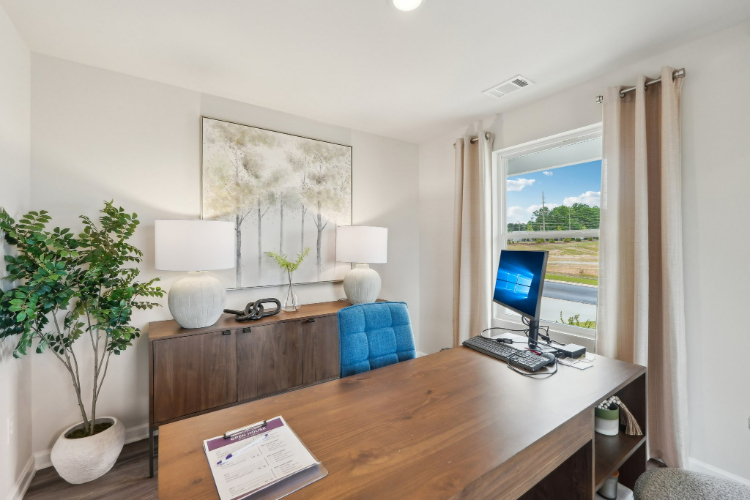 A room with a desk and a computer.