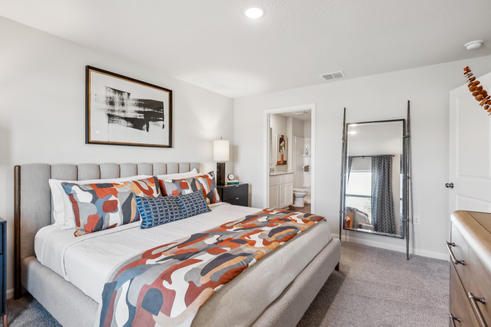 A bedroom with a bed and a door.