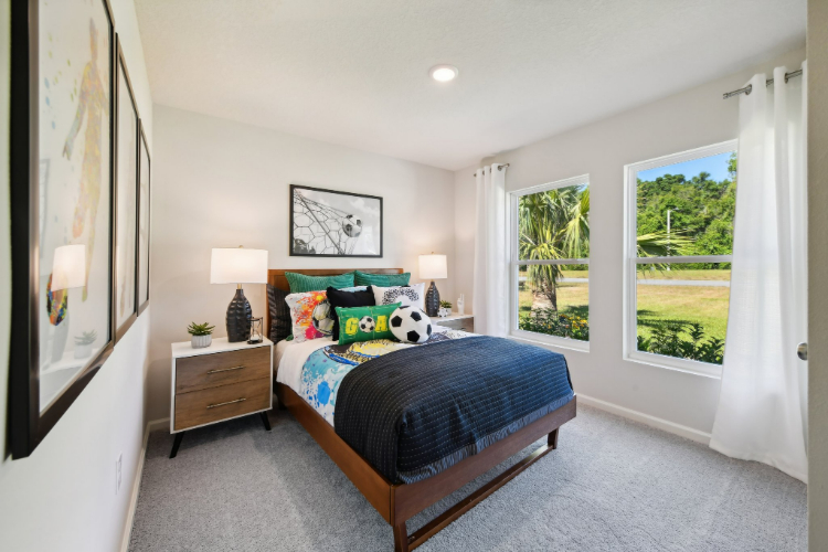A bedroom with a bed and a window.