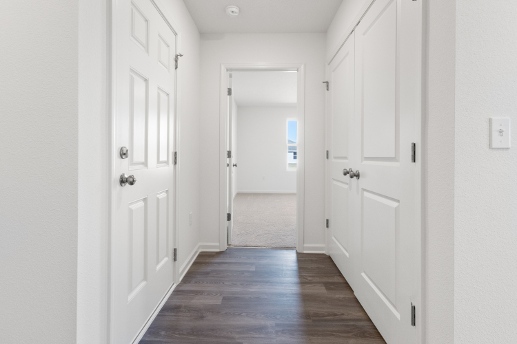 A hallway with white doors.