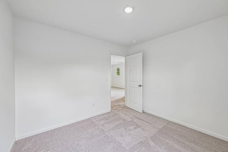 A hallway with white walls.