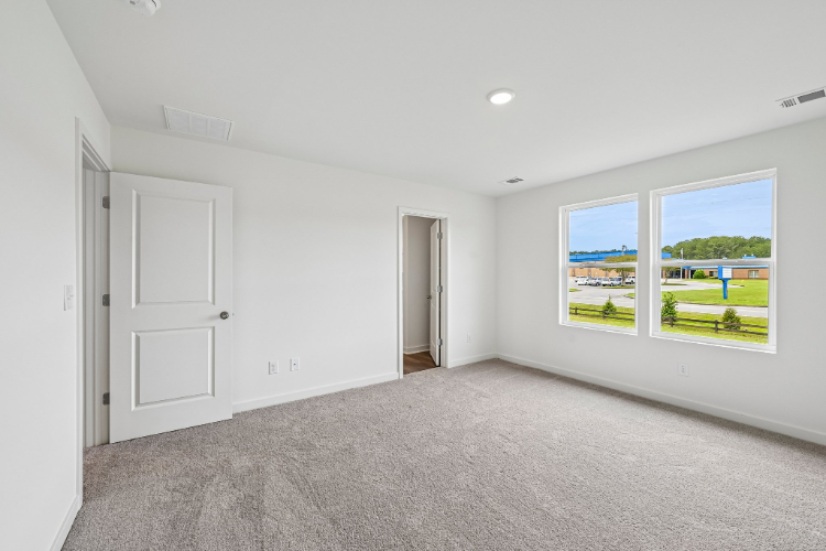 A room with white walls and a large window.