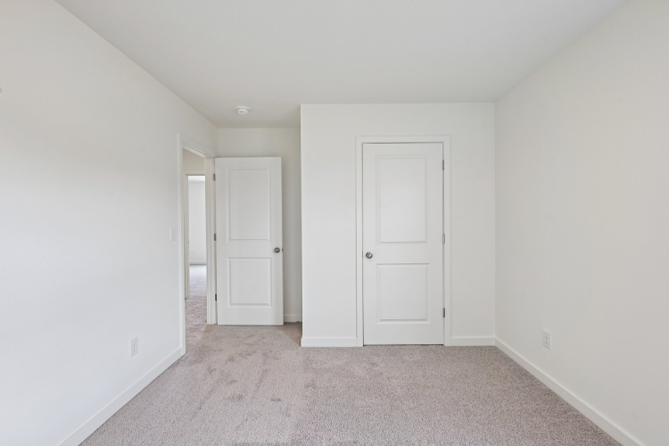 A hallway with white doors.