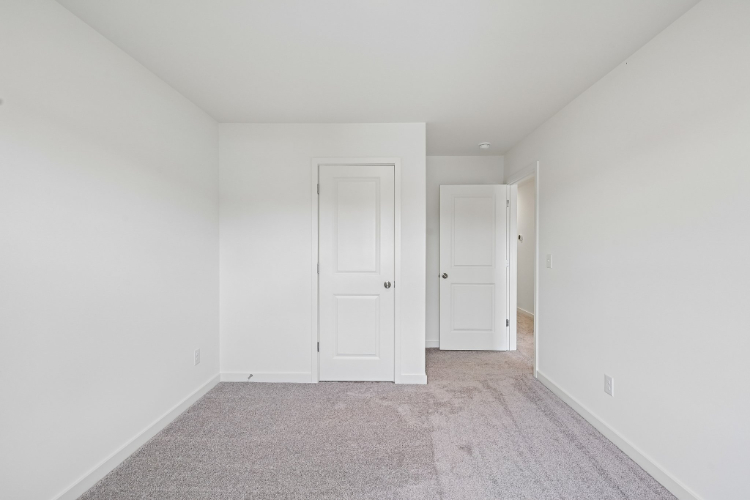A hallway with white doors.