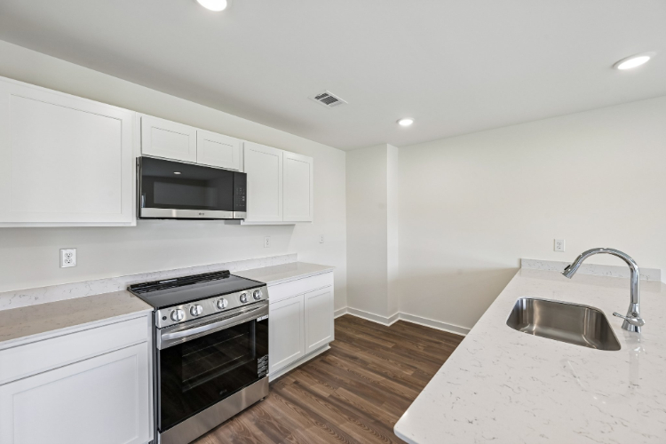 A kitchen with white cabinets.