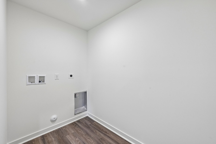 A white room with a wood floor.