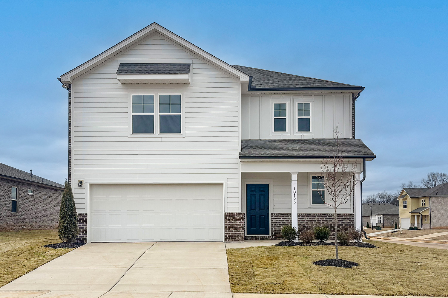 A white house with a garage.