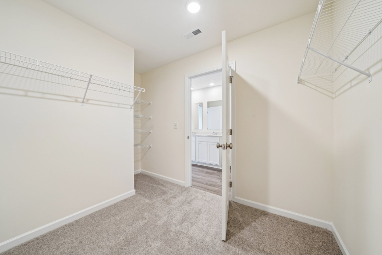 A hallway with a door and a glass window.